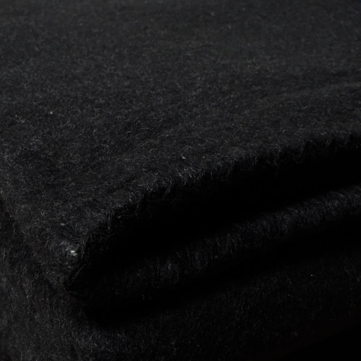 Texture detail of folded soft black cotton blanket for Dreamcase car bedding set