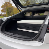 DreamCase white custom carrying case stored in Tesla Model S trunk