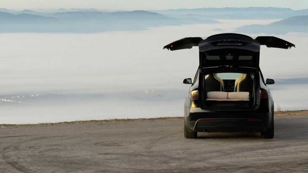 Tesla car bed for camping with Dreamcase Model X mattress facing mountain viewpoint