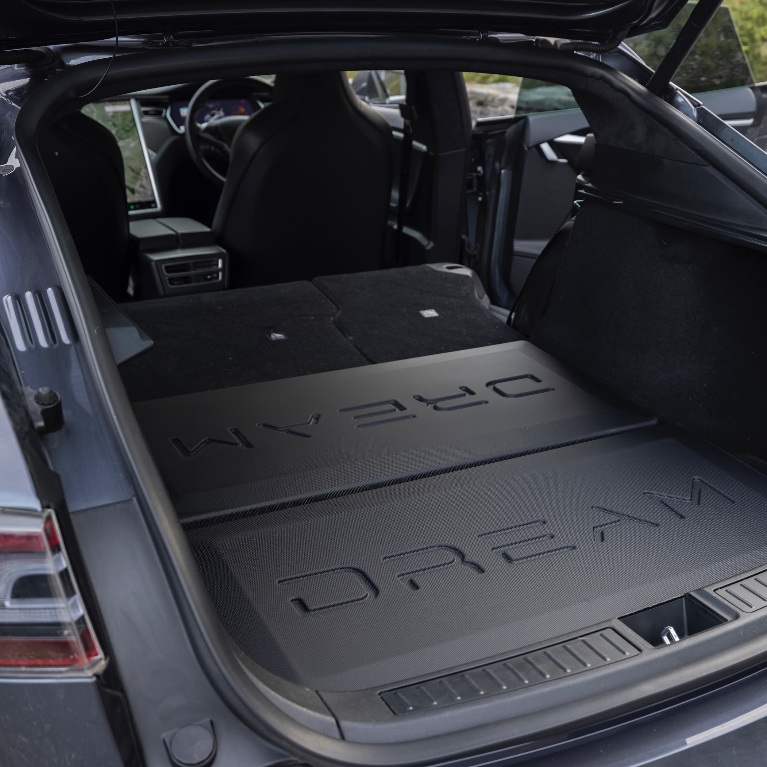 Perspective view of the ABS hard shell lining the Tesla trunk floor to elevate and level the bed area