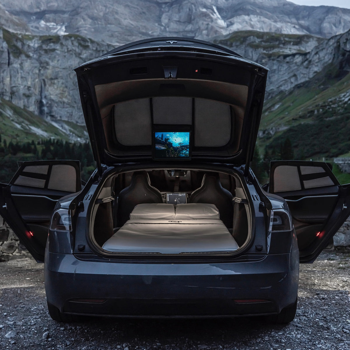 Unfolded Dreamcase Classic foam mattress set up for sleeping inside Tesla Model S with open tailgate