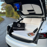 DreamCase white car mattress set up in couch mode inside Tesla Model S trunk
