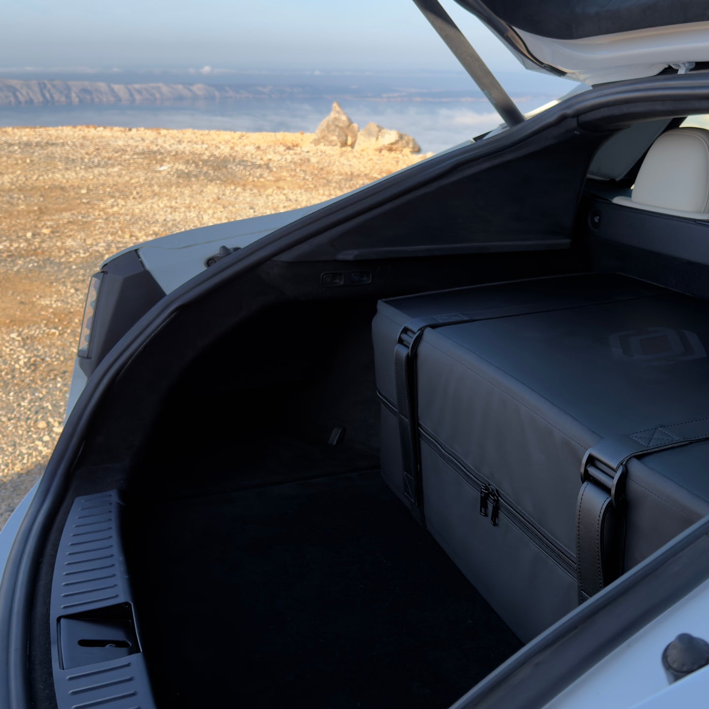 DreamCase Comfort car mattress packed into compact hardcover suitcase in Tesla Model S Plaid trunk