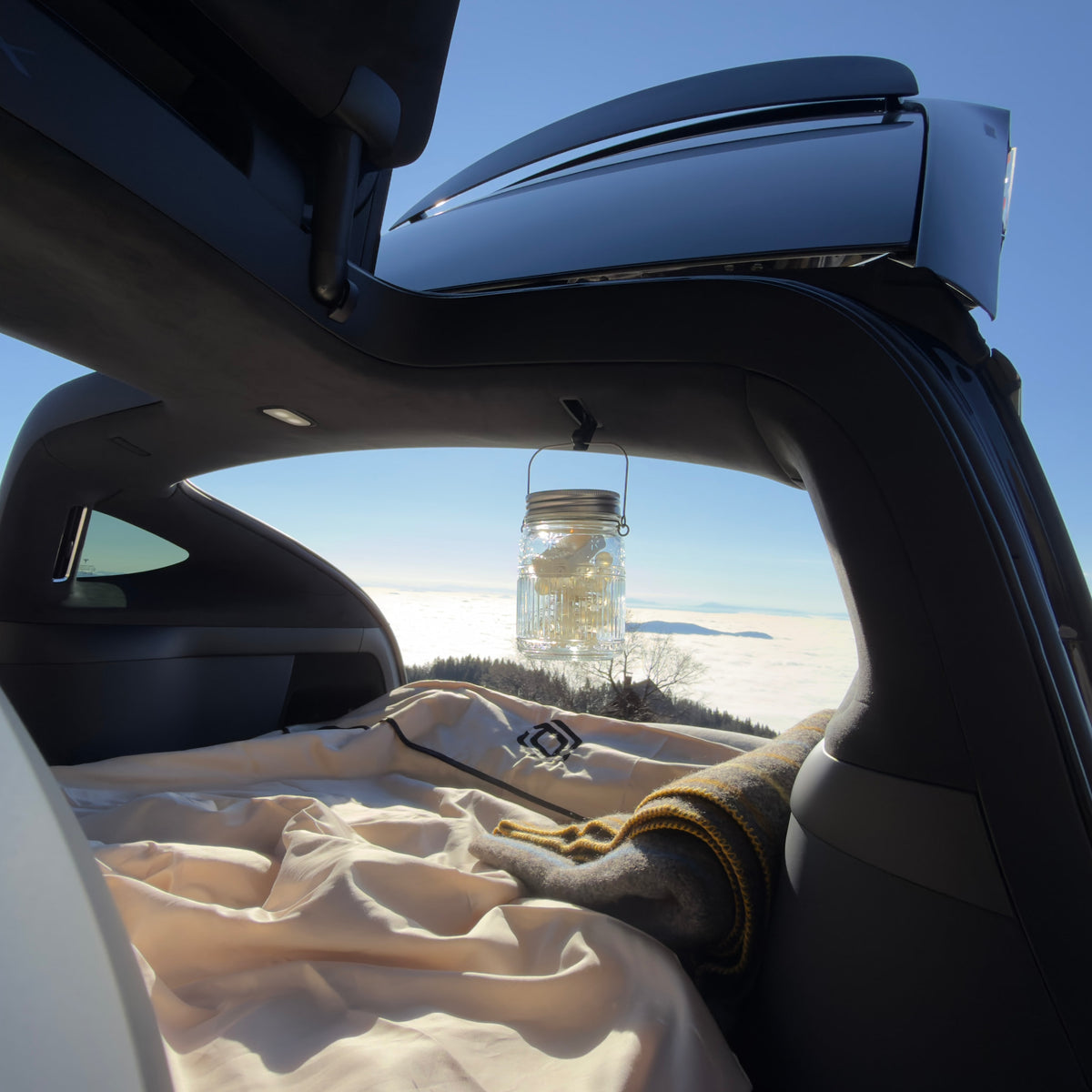 Dreamcase car bed mattress inside Tesla Model X camping above clouds